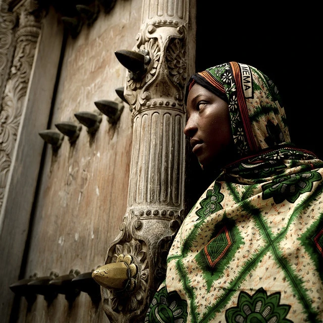 Zanzibari girl wearing kanga, at a Zanzibar Door